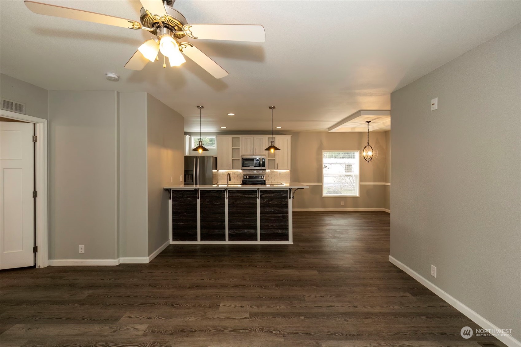 17340 Sargent Road Southwest, Unit 24 Rochester, WA 98579 - Photo 10 of 26 wooden floor in an empty room with a window