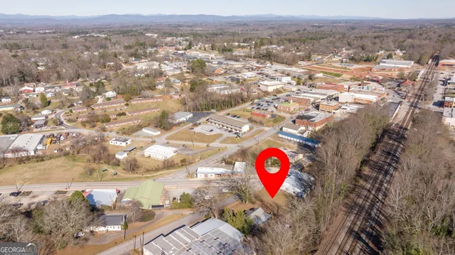 an aerial view of residential house and sandy dunes