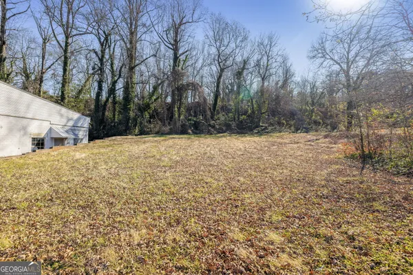 a view of white house with a yard