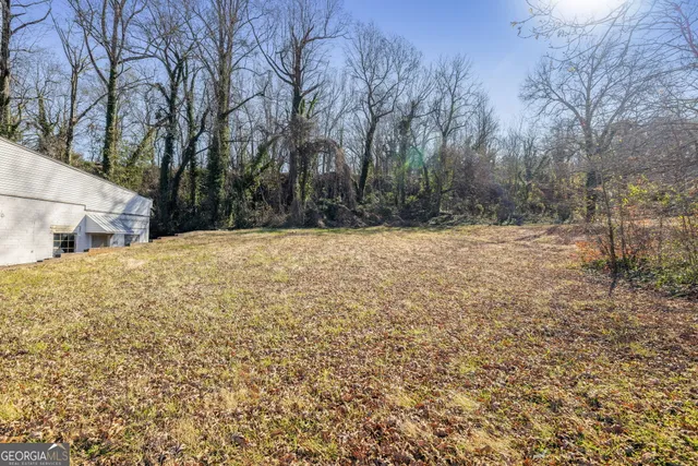 a view of white house with a yard