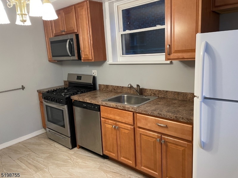 357 Franklin Street, Unit 8 Bloomfield, NJ 07003 - Photo 1 of 5 a kitchen with granite countertop cabinets stainless steel appliances and a sink