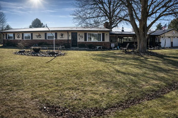 a front view of a house with yard patio and green space