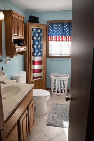 a bathroom with a sink toilet vanity and shower