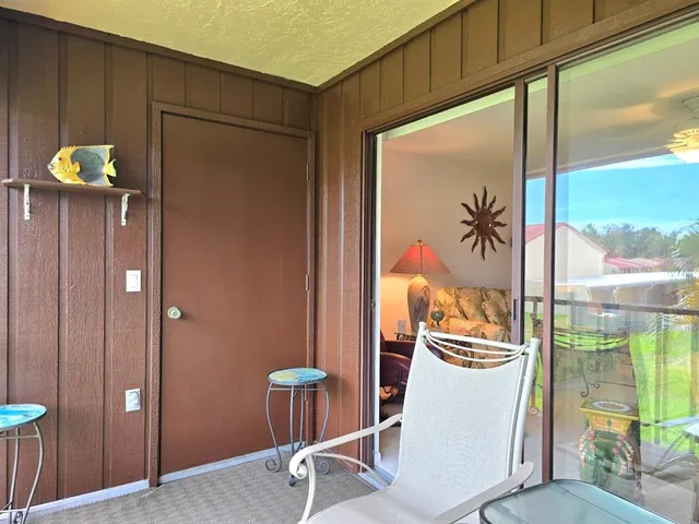 a very nice looking room with a glass door and furniture