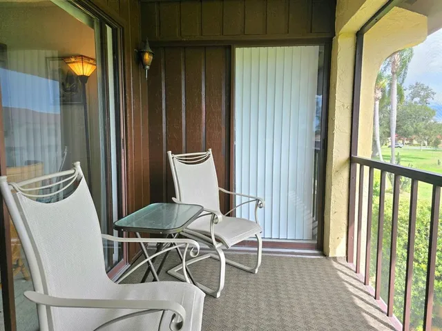 a view of a balcony with chairs