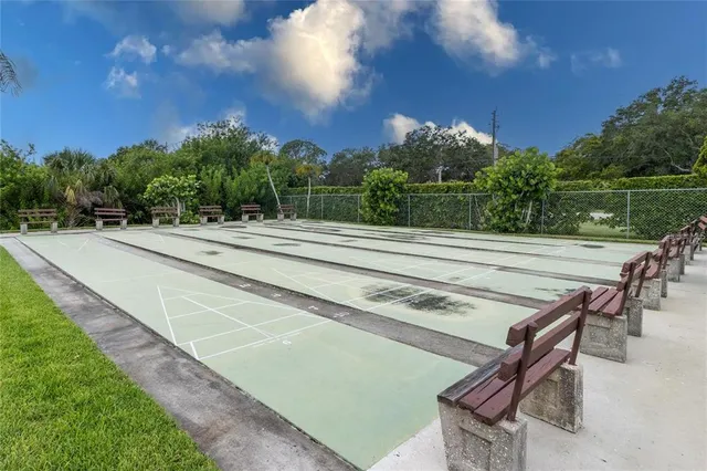 a view of a patio with swimming pool and sitting area