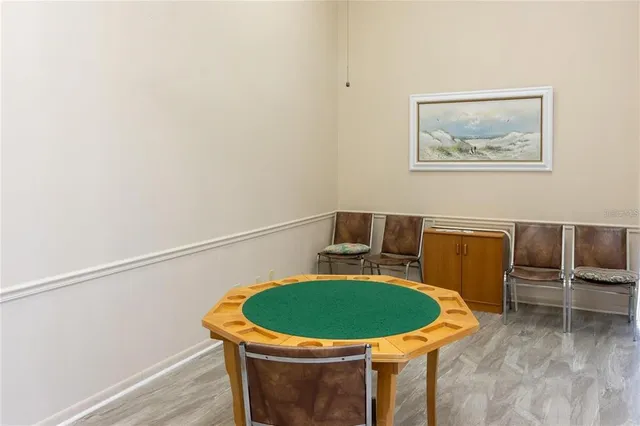 a view of a room with a table and chairs