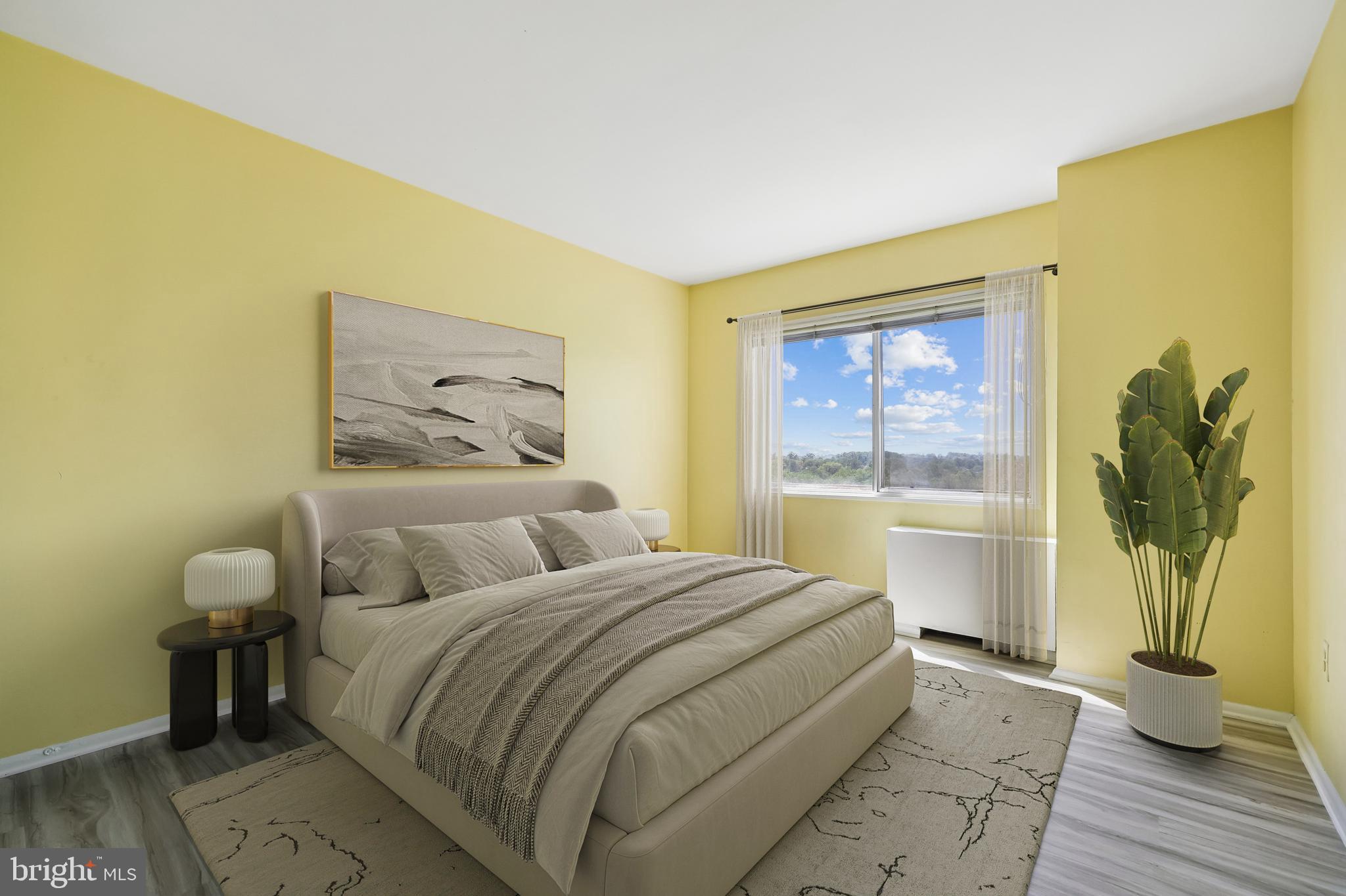 1111 University Boulevard West, Unit 1106A Silver Spring, MD 20902 - Photo 16 of 35 a bedroom with a bed and a painting on the wall
