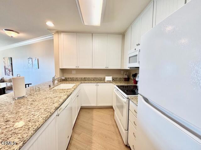 3101 Peninsula Road, Unit 217 Oxnard, CA 93035 - Photo 9 of 17 a kitchen with granite countertop a sink and cabinets