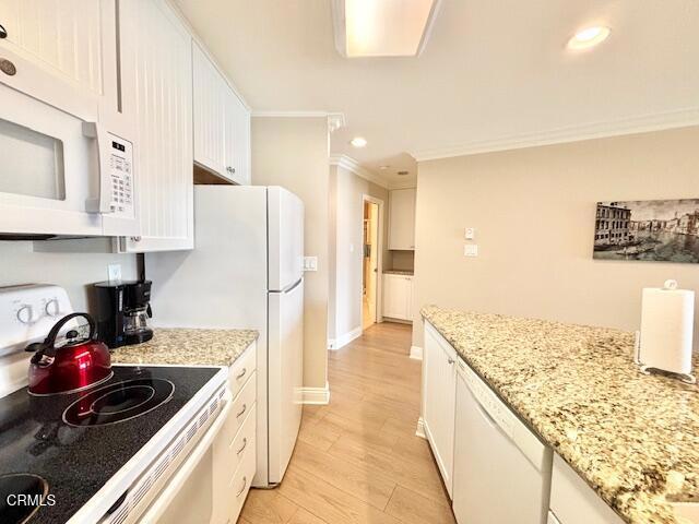 3101 Peninsula Road, Unit 217 Oxnard, CA 93035 - Photo 10 of 17 a kitchen with stainless steel appliances granite countertop a sink stove and refrigerator