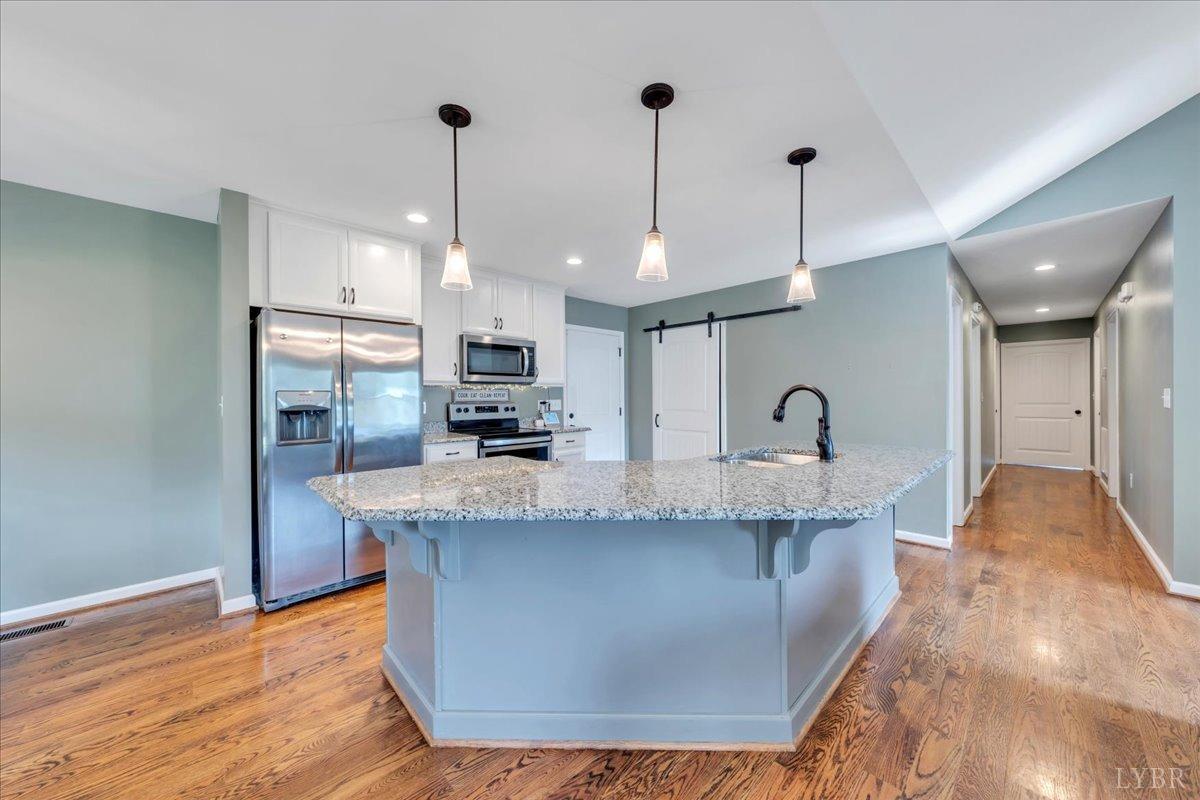 1400 Mountain Cut Road Appomattox, VA 24522 - Photo 11 of 55 a large kitchen with stainless steel appliances granite countertop a sink a counter space and cabinets