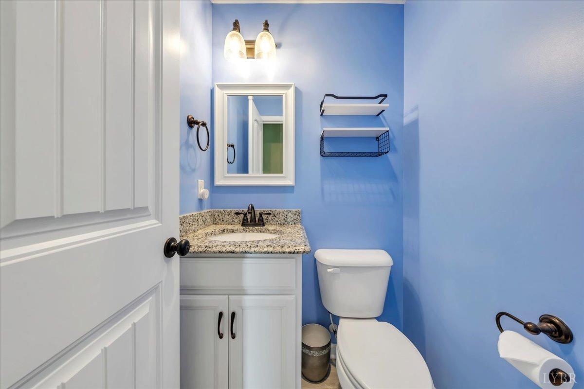 1400 Mountain Cut Road Appomattox, VA 24522 - Photo 17 of 55 a bathroom with a toilet a sink and mirror
