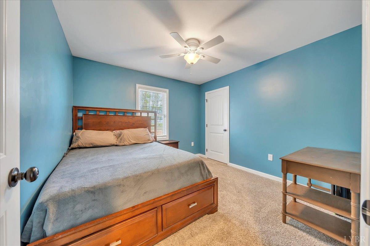 1400 Mountain Cut Road Appomattox, VA 24522 - Photo 18 of 55 a bedroom with a bed and a chandelier