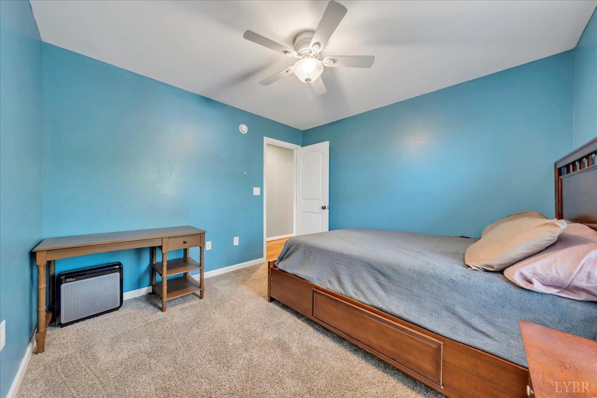 1400 Mountain Cut Road Appomattox, VA 24522 - Photo 19 of 55 a bedroom with a bed and a chandelier