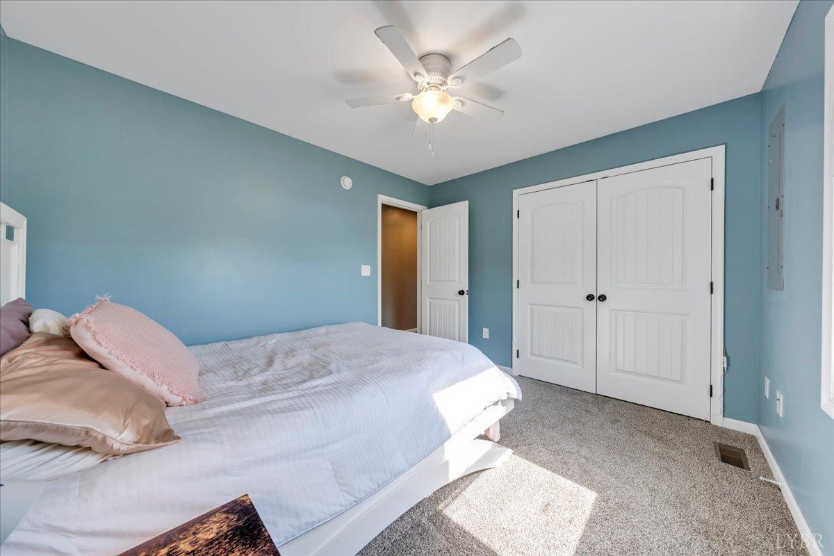 1400 Mountain Cut Road Appomattox, VA 24522 - Photo 22 of 55 a bedroom with a large bed and a ceiling fan
