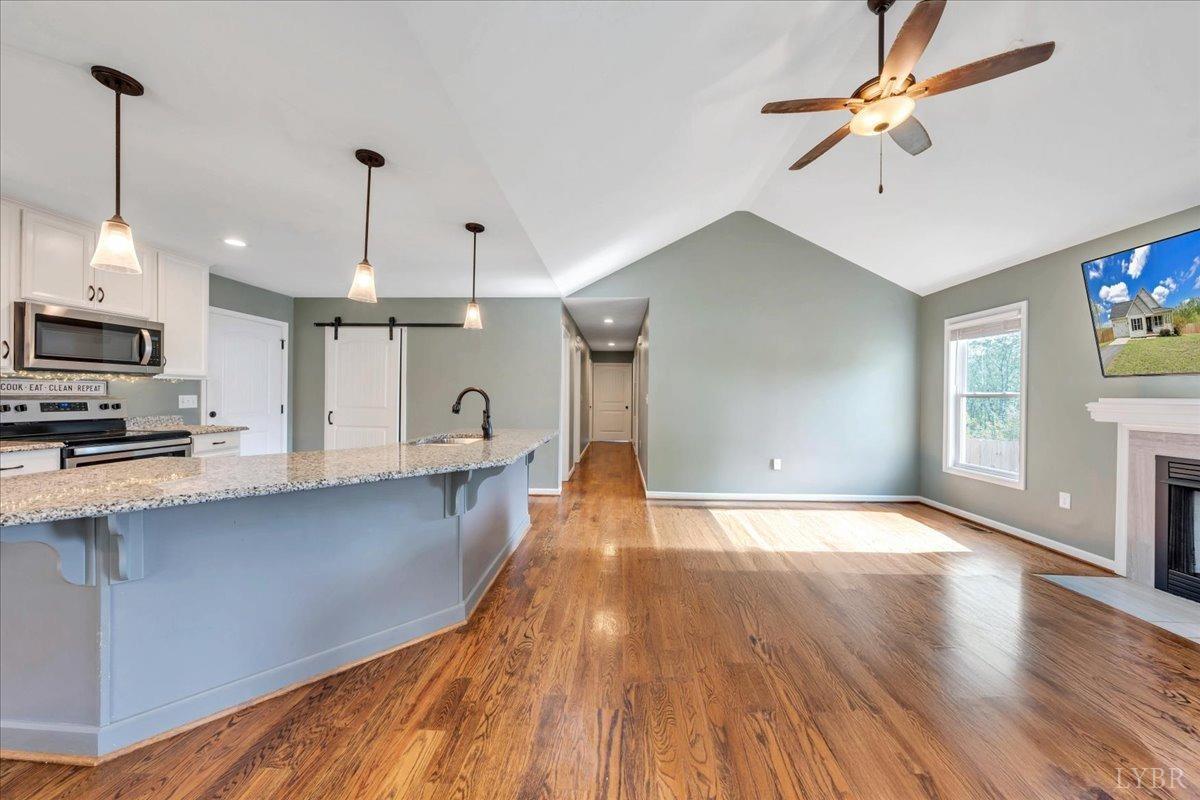 1400 Mountain Cut Road Appomattox, VA 24522 - Photo 6 of 55 a view of a kitchen with wooden floor a sink a refrigerator and window