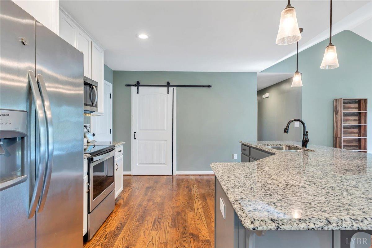 1400 Mountain Cut Road Appomattox, VA 24522 - Photo 10 of 55 a kitchen with stainless steel appliances granite countertop a refrigerator a sink and wooden floor