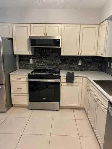 a kitchen with cabinets and appliances