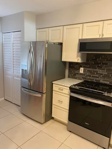a kitchen with stainless steel appliances granite countertop a stove and a refrigerator