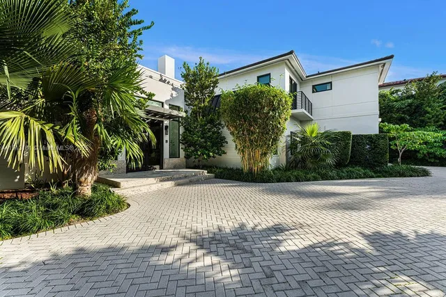 a front view of a house with a yard and a garage