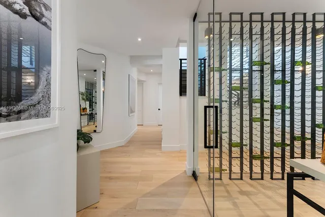 a view of a hallway with wooden floor and windows