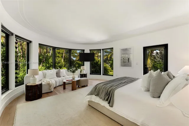 a bedroom with a large bed and a large window