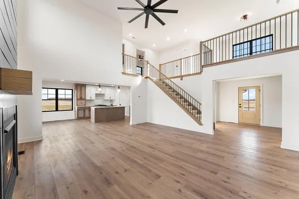 a large kitchen with stainless steel appliances granite countertop a large counter top and wooden floors
