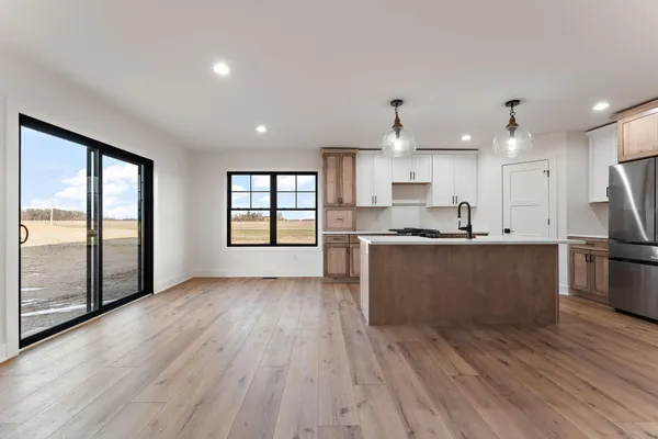 a kitchen with stainless steel appliances granite countertop a sink stove and refrigerator