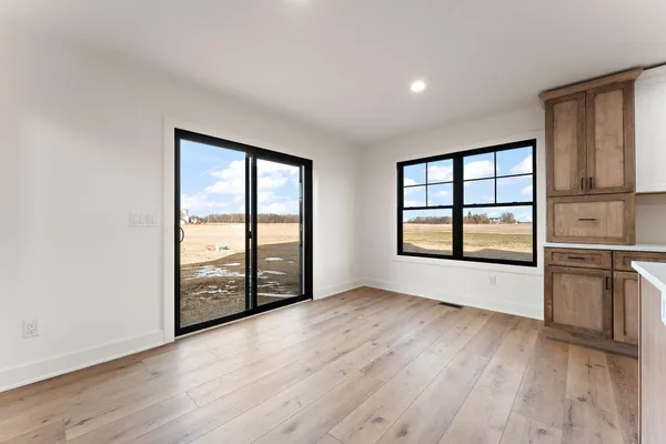 a kitchen with stainless steel appliances granite countertop a refrigerator a sink a stove and white cabinets