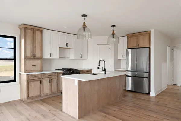 a kitchen with stove a sink and refrigerator