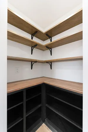 a view of a room that has a window and a ceiling fan