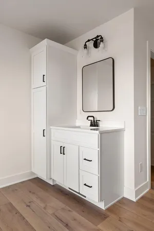 a close view of a sink and dishwasher with wooden floor