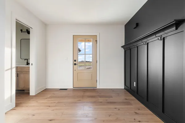 a view of a livingroom with wooden floor and a ceiling fan