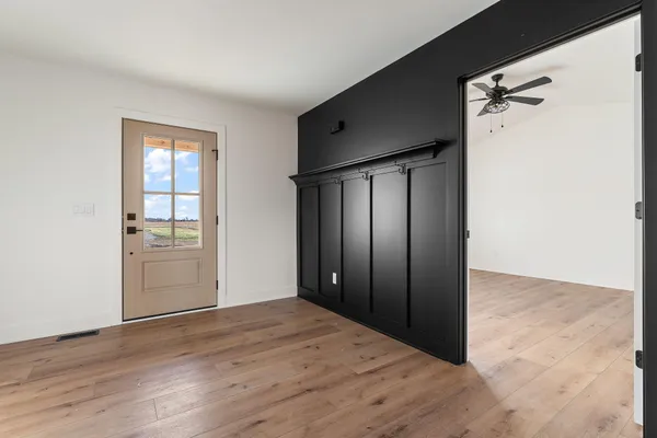 a view of an empty room with a window and fireplace