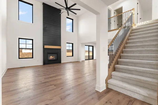 a view of a livingroom with wooden floor and a fireplace