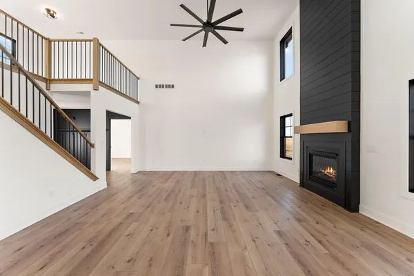 a large kitchen with stainless steel appliances granite countertop a stove and a large window