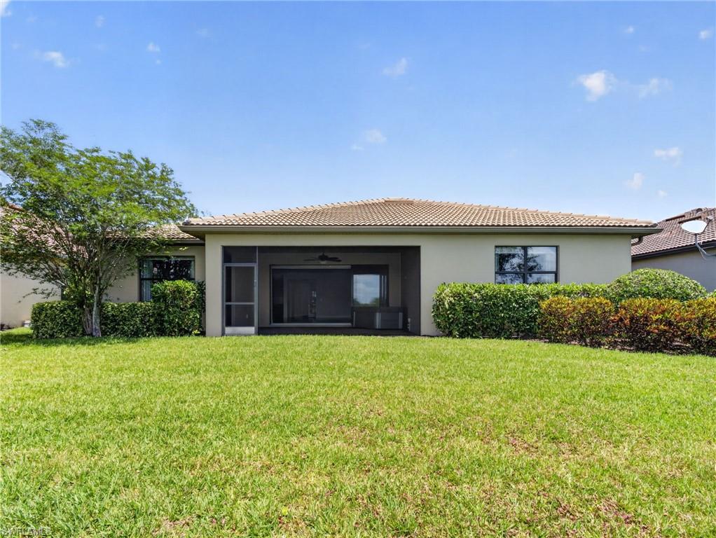 6124 Victory Drive Ave Maria, FL 34142 - Photo 40 of 50 a front view of a house with a yard and garage