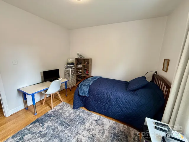 a bedroom with a bed and a desk in it