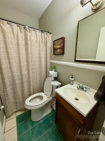 a bathroom with a sink a toilet and mirror