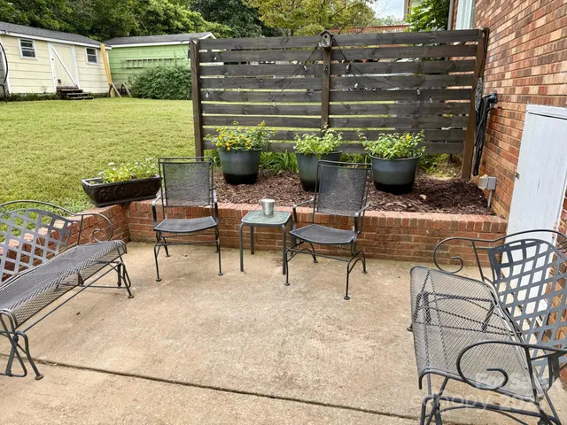 a backyard of a house with outdoor seating
