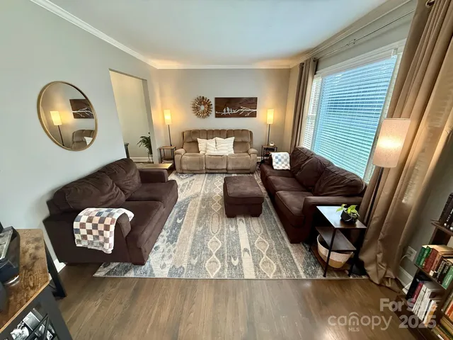 a living room with furniture and a mirror