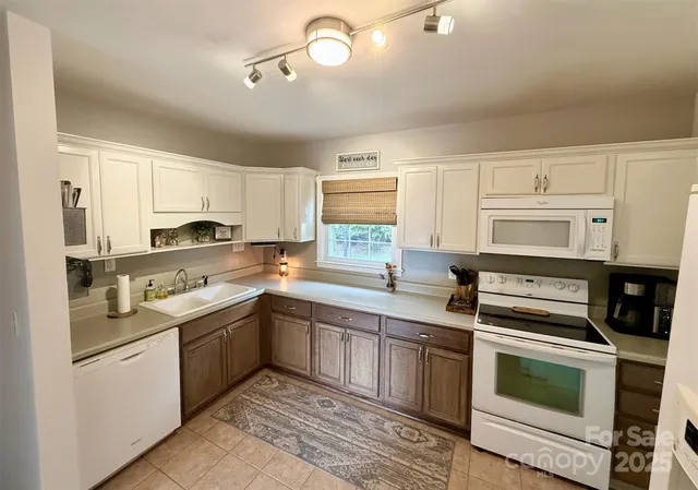 a kitchen with a sink stove and cabinets