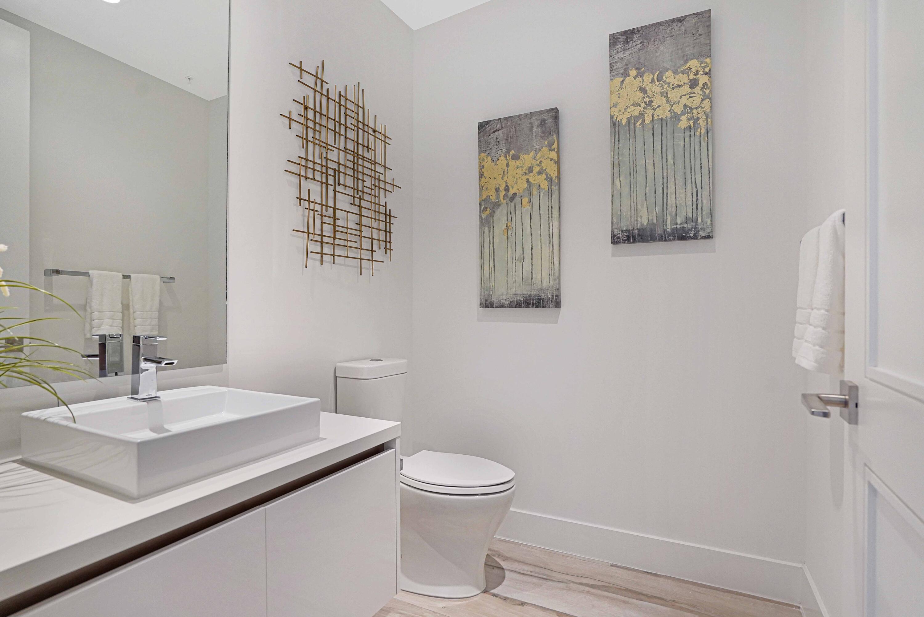 155 East Boca Raton Road, Unit 916 Boca Raton, FL 33432 - Photo 26 of 72 a bathroom with a sink a toilet and mirror