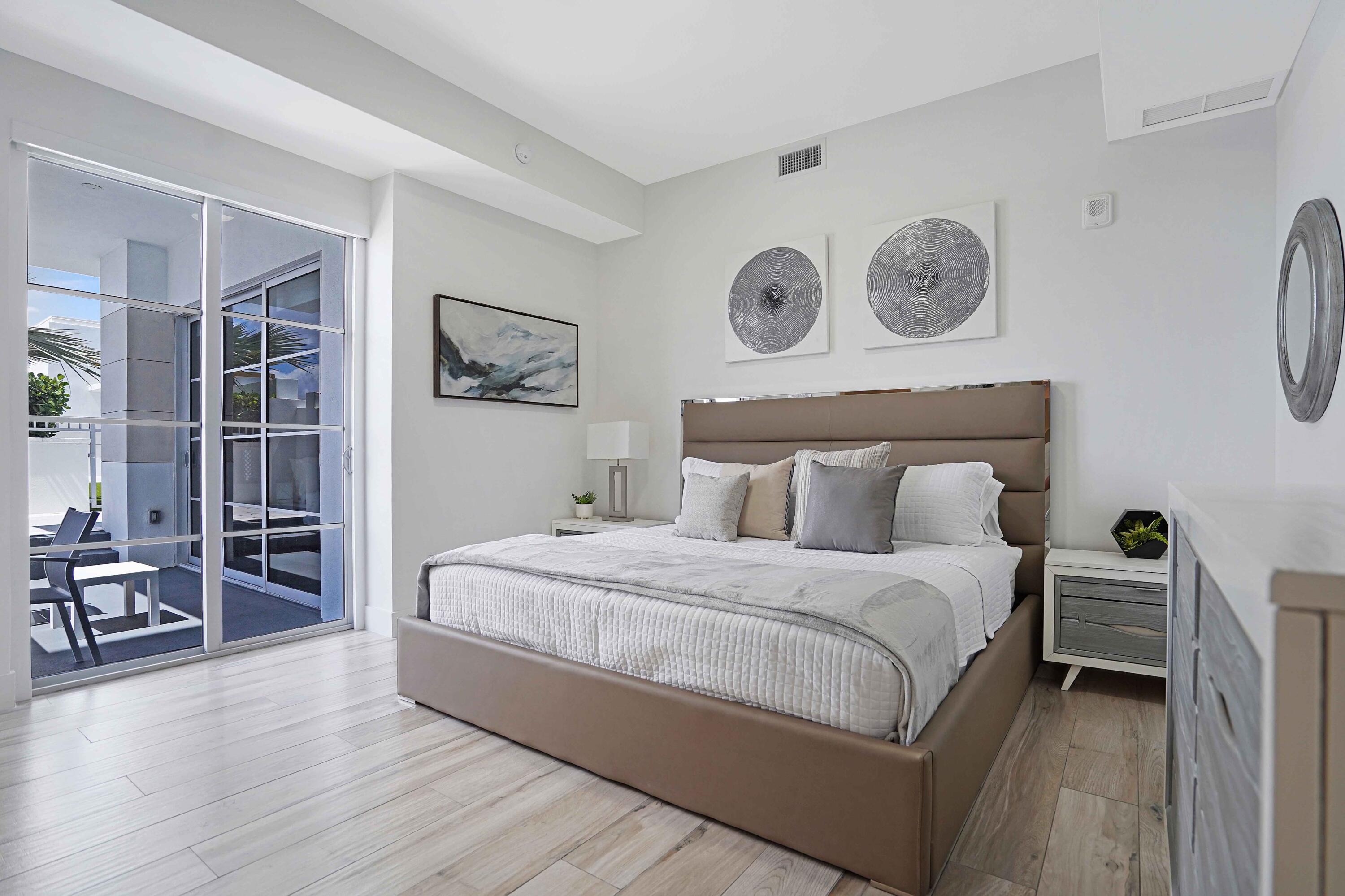 155 East Boca Raton Road, Unit 916 Boca Raton, FL 33432 - Photo 6 of 72 a bedroom with bed and paintings on the wall