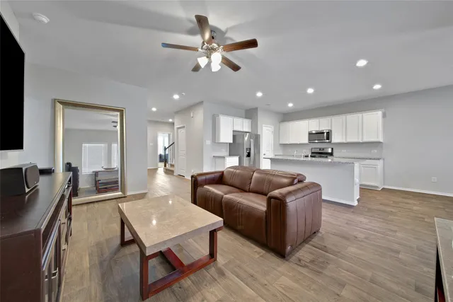 a living room with furniture and kitchen view