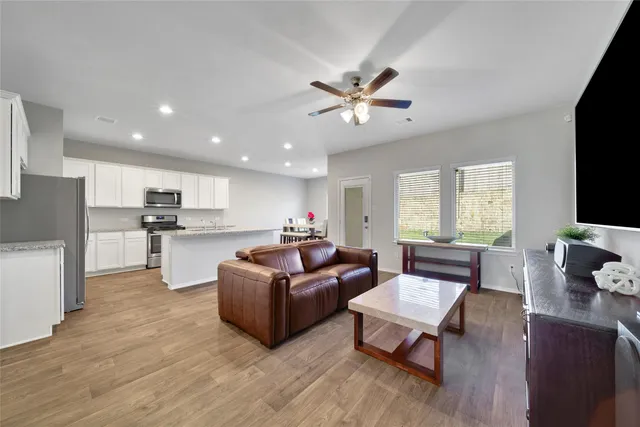 a living room with furniture and a flat screen tv