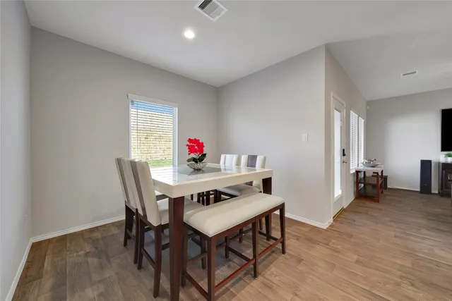 a view of a dining room with furniture and wooden floor