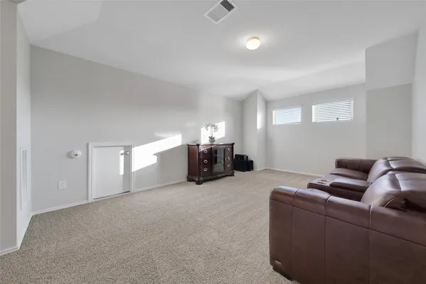 a bed room with furniture and air conditioner vent