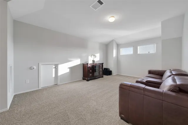 a bed room with furniture and air conditioner vent