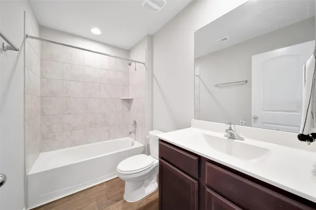 a bathroom with a sink a toilet and bathtub